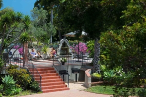 outdoor seating area with fountain and tanning chairs