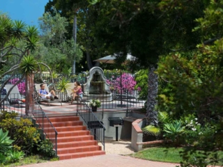 outdoor seating area with fountain and tanning chairs