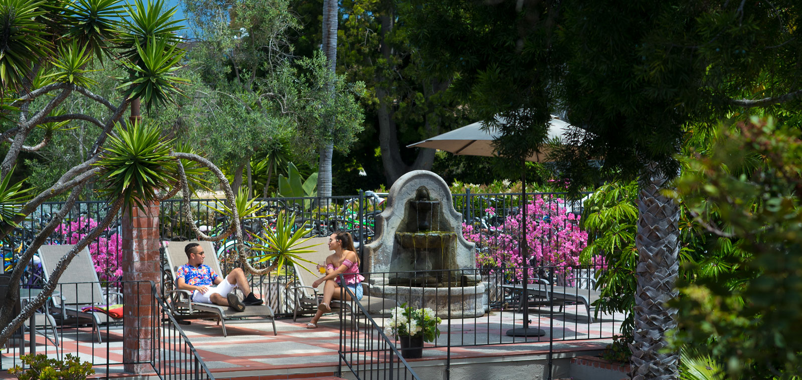 outdoor area with tanning chairs and fountain